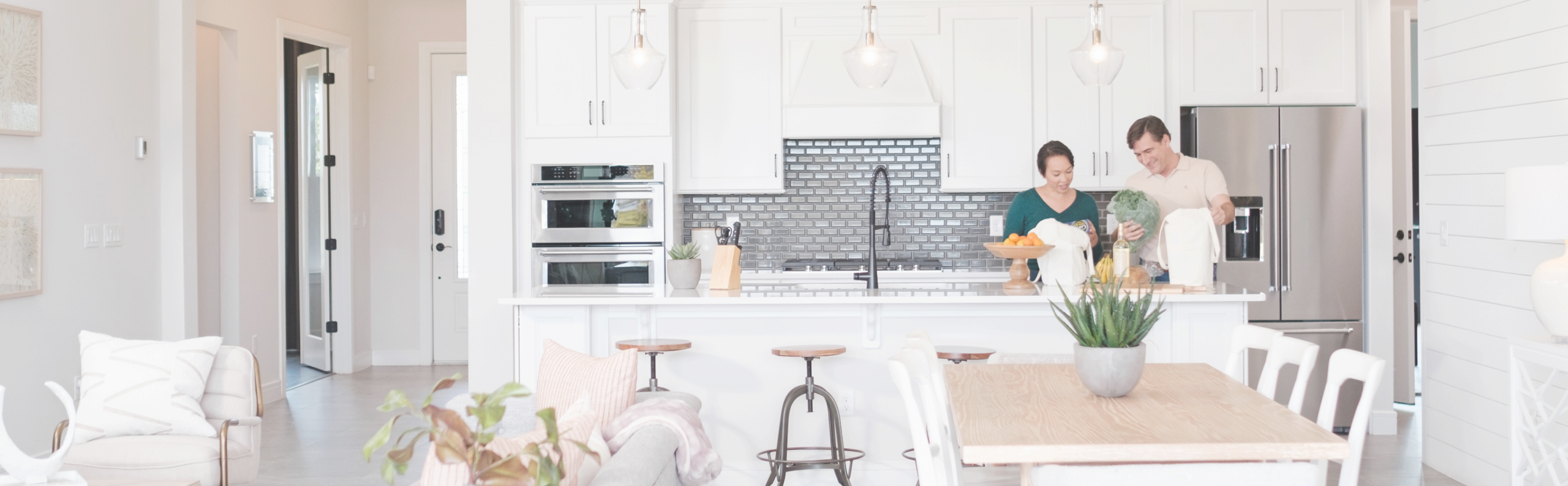 couple unpacks groceries in their modern open concept kitchen